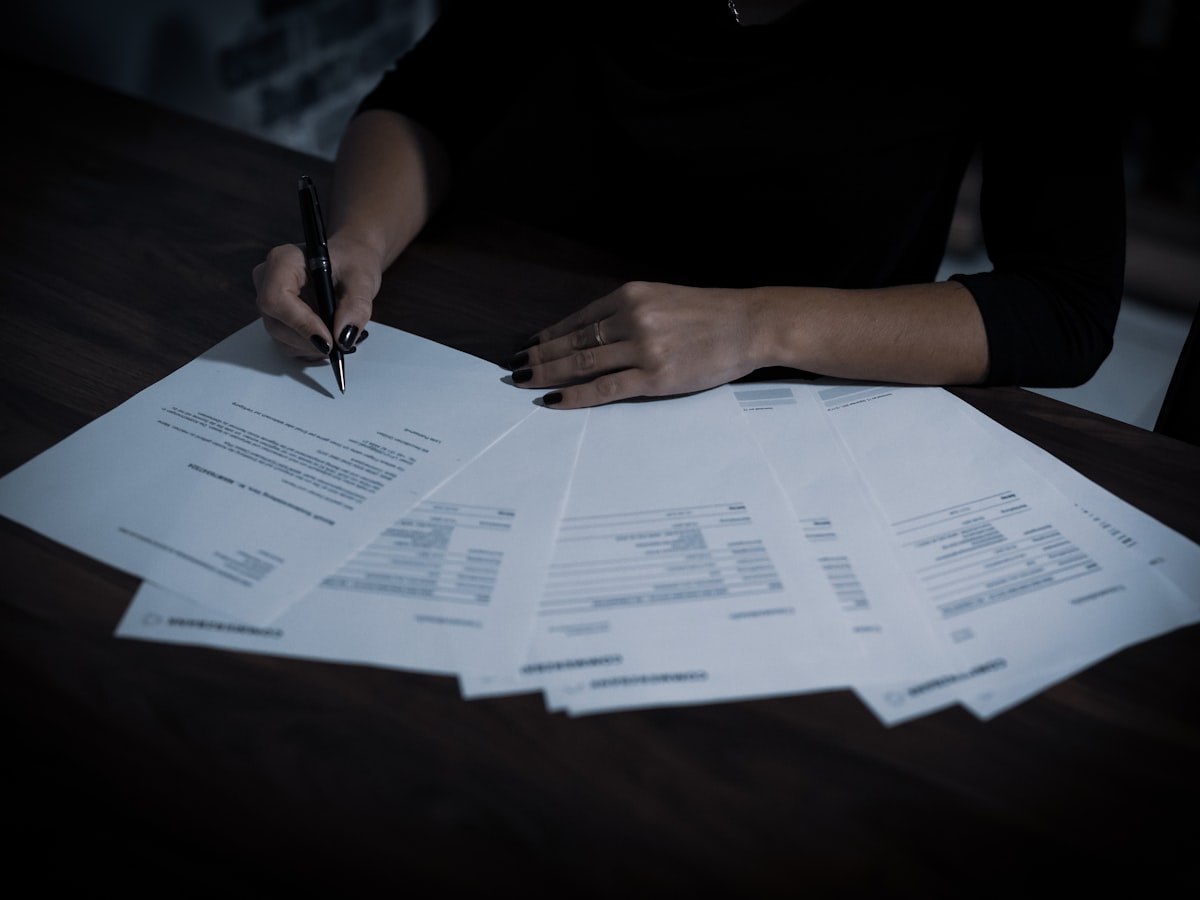 Auditor reviewing a spread of financial documents