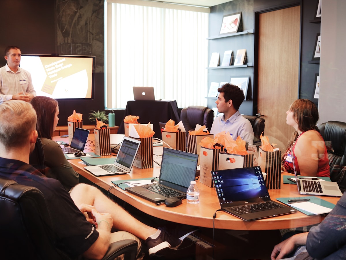 Coach leading a team training session at a conference table